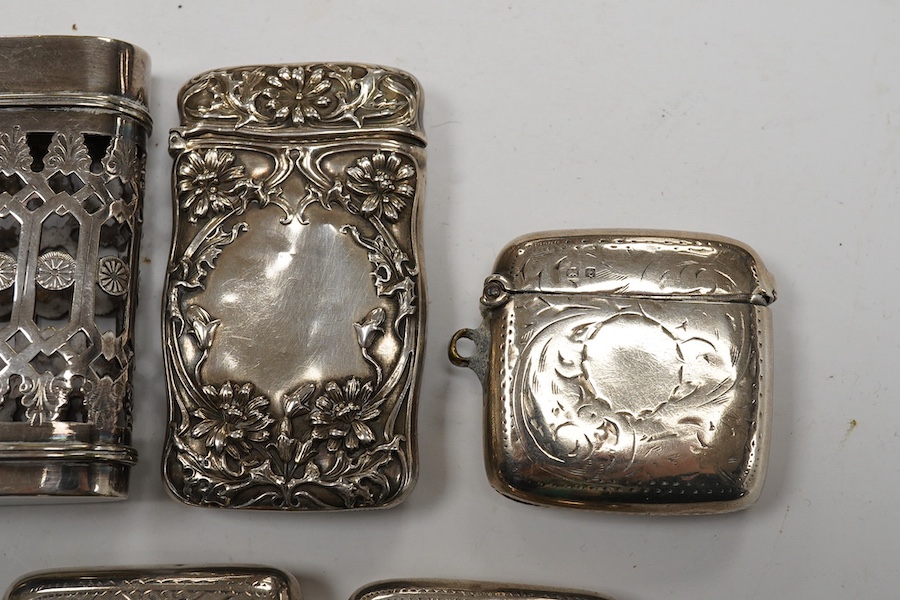 Seven assorted late 19th/early 20th century silver vesta cases, largest 48mm, a sterling case and one other pierced white metal case. Condition - poor to fair